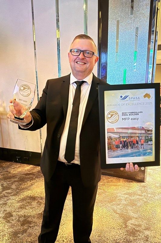 Karl Brown, Managing Director of MFP Easy, holding the gold trophy and certificate for SPASA Best Fibreglass Pool Builder 2025