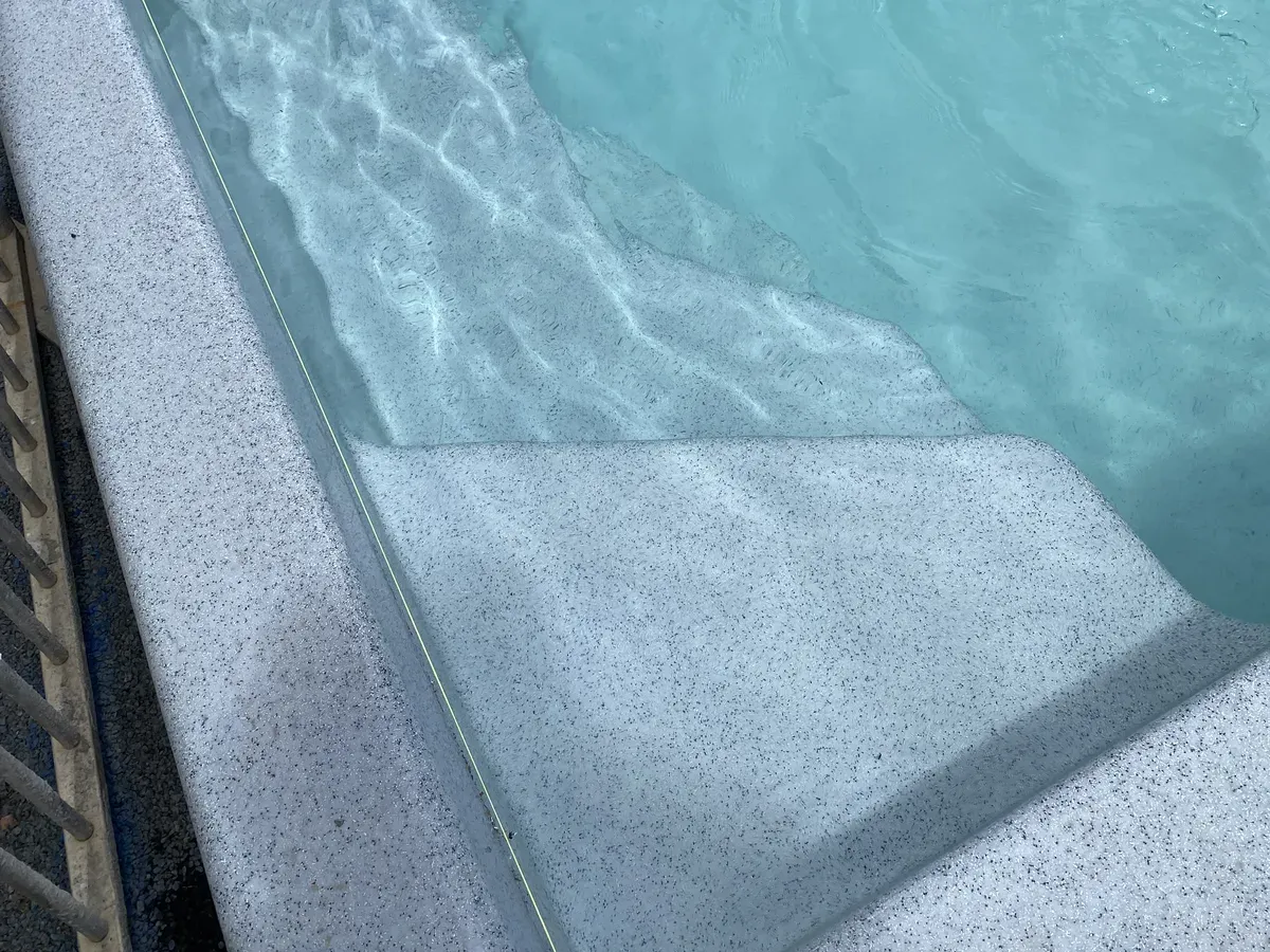 Clear water over the moulded gelcoat steps of a newly finished MFP fibreglass pool