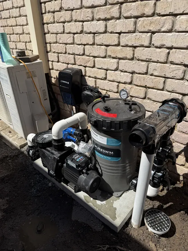 PureSwim mineral chlorinator, cartridge filter and pump on the equipment pad of a new MFP pool