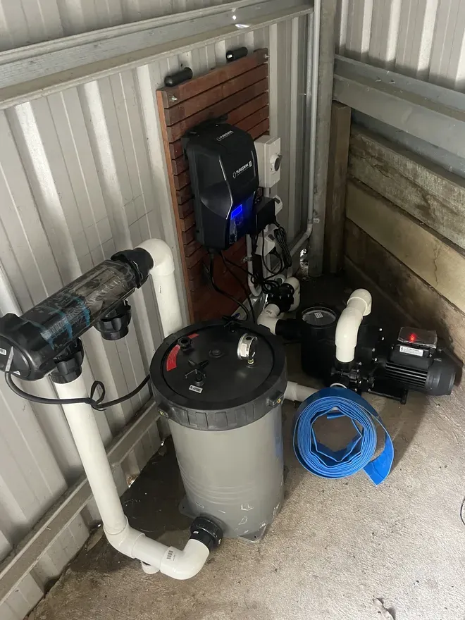 PureSwim chlorinator cell, wall-mounted controller, cartridge filter and pump in the equipment corner of an MFP pool