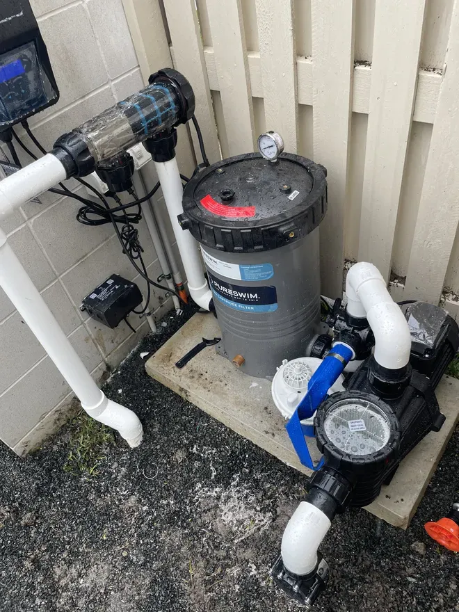 PureSwim chlorinator cell, cartridge filter and pump on the equipment pad of a new MFP pool