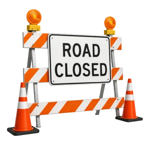 All-day road closure sign on barrier boards with cones and lamps