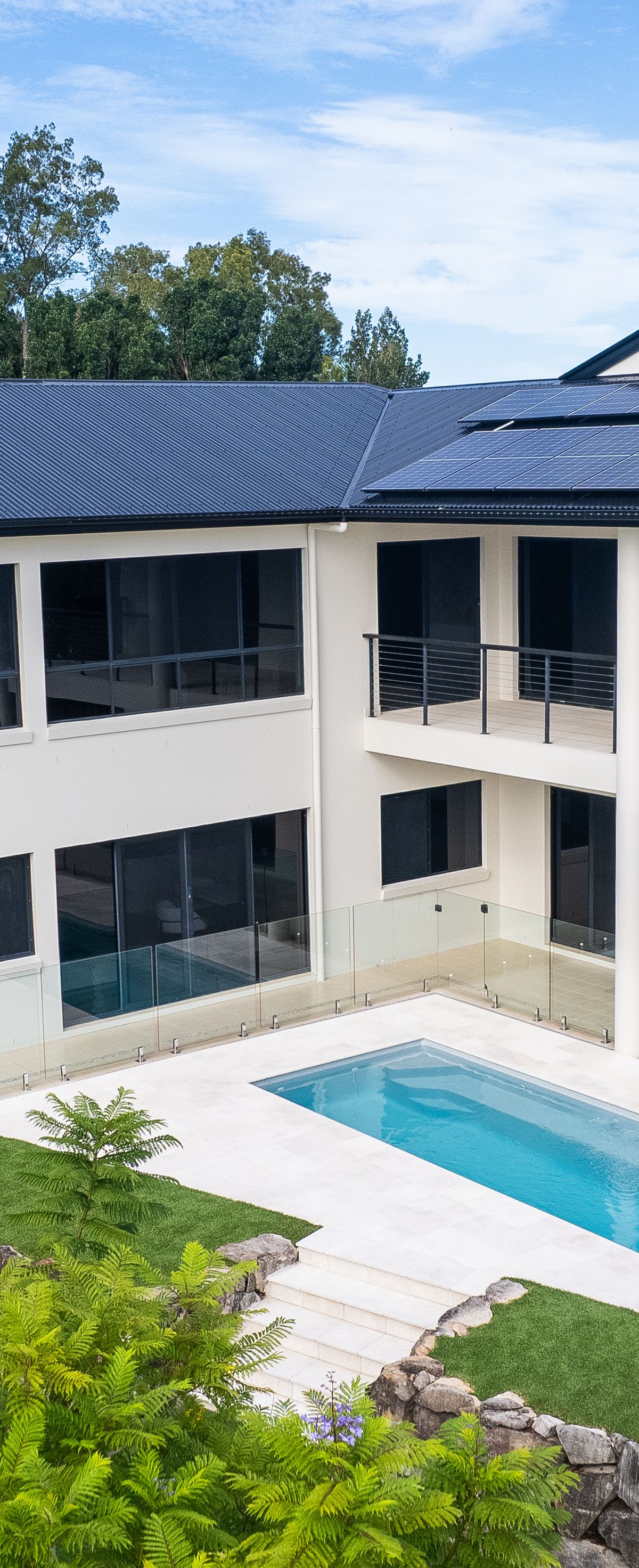 Landscaped family fibreglass pool with lawn and garden on the Gold Coast