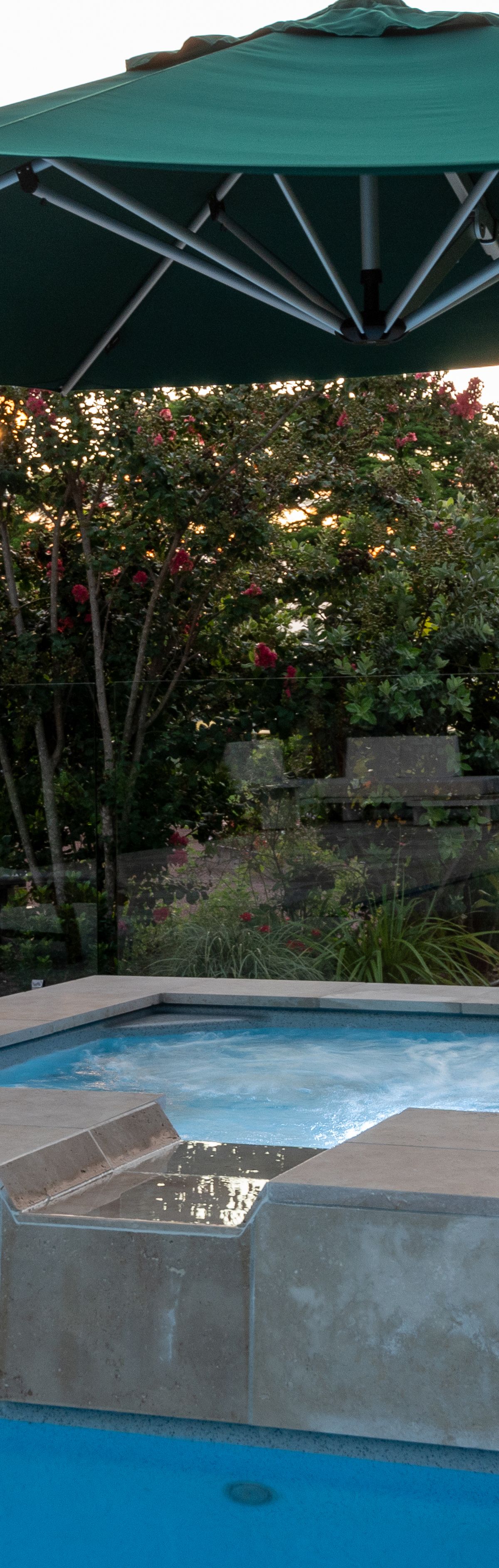 LED pool and spa lighting at dusk around a fibreglass pool in Booval