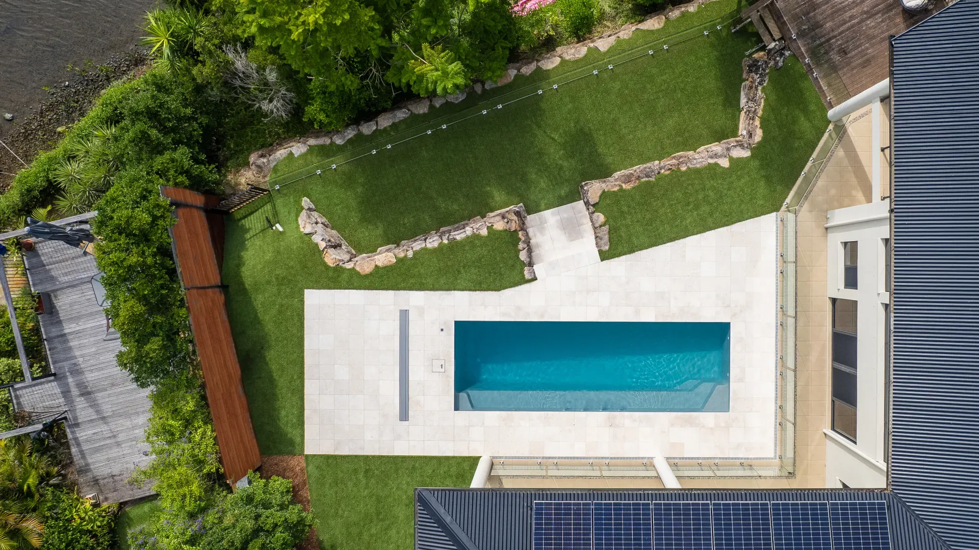 Long narrow fibreglass lap pool running down the side of a home