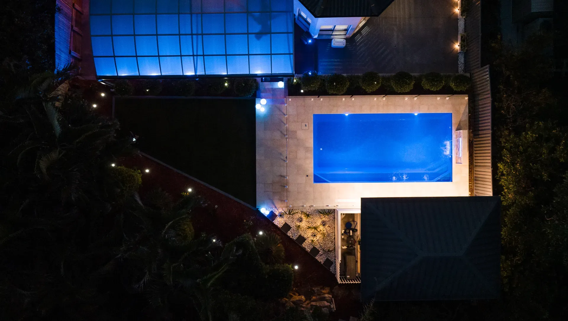 Fibreglass pool glowing with LED lighting at dusk