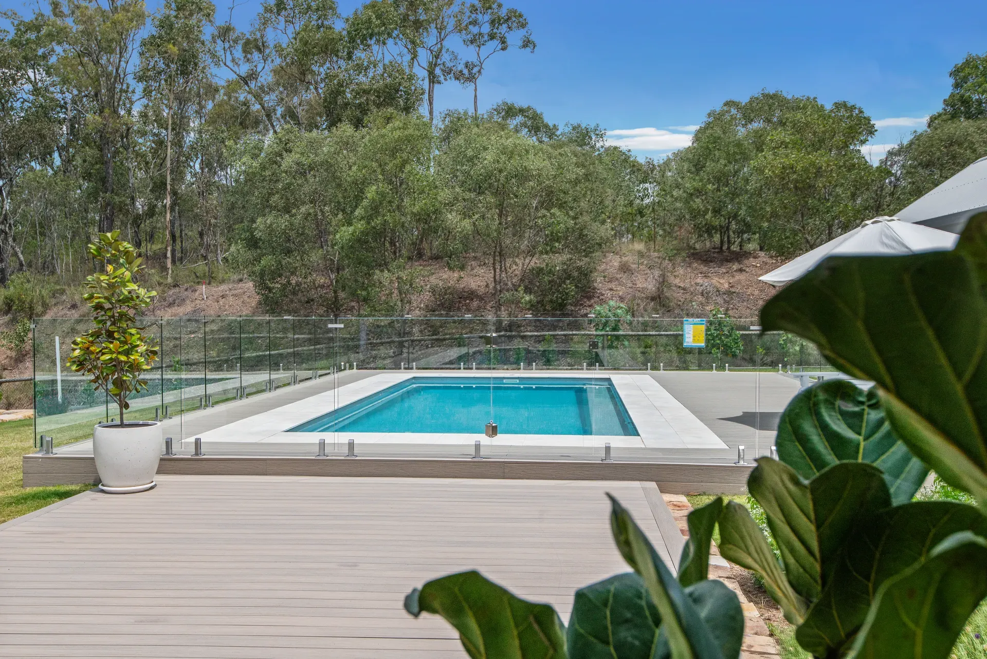 Fibreglass pool with paved surround at dusk